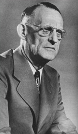 Black-and-white vintage portrait of Dr. Bob, co-founder of Alcoholics Anonymous, wearing glasses, a suit, and tie